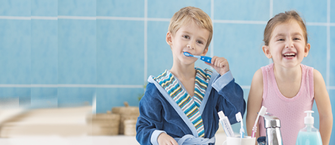 Boy and girl brushing their teeth